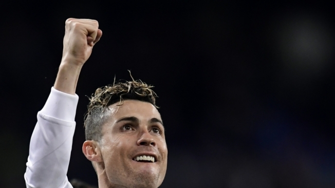 Real Madrid's Portuguese forward Cristiano Ronaldo celebrates his fourth goal during the Spanish League football match between Real Madrid CF and Girona FC at the Santiago Bernabeu stadium in Madrid on March 18, 2018. / AFP PHOTO / JAVIER SORIANO