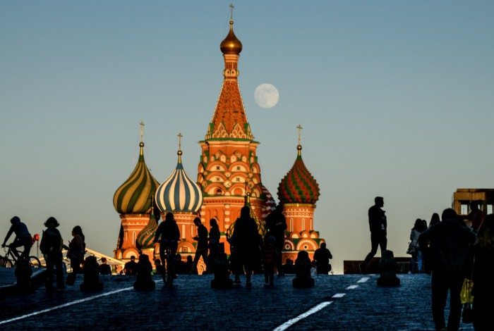 A picture shows the moon over Saint Basil's Cathedral on the Red Square in Moscow on May 28, 2018.