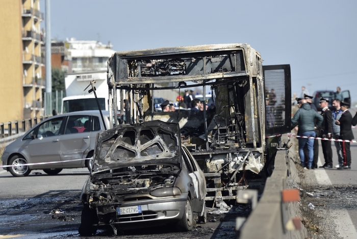 The wreckage of a school bus that was transporting some 50 children is pictured on March 20, 2019 after it was torched by the bus' driver, in San Donato Milanese, southeast of Milan. - Italian police rescued some 50 children on March 20, 2019 after their driver threatened to torch their school bus which he doused with petrol, the authorities said. 