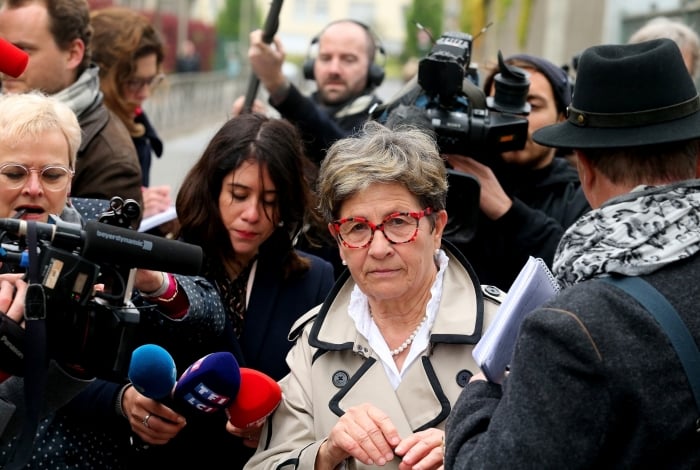 Viviane Lambert (C), the mother of Vincent Lambert, a quadriplegic man who has been in a vegetative state for the last decade, walks out Sebastopol hospital in Reims on May 20, 2019 as doctors began switching off the life support. - The dispute over the fate of Vincent Lambert has split his own family and even become a subject of political tension in France ahead of the weekend's European elections. (Photo by FRANCOIS NASCIMBENI / AFP)
      Caption
