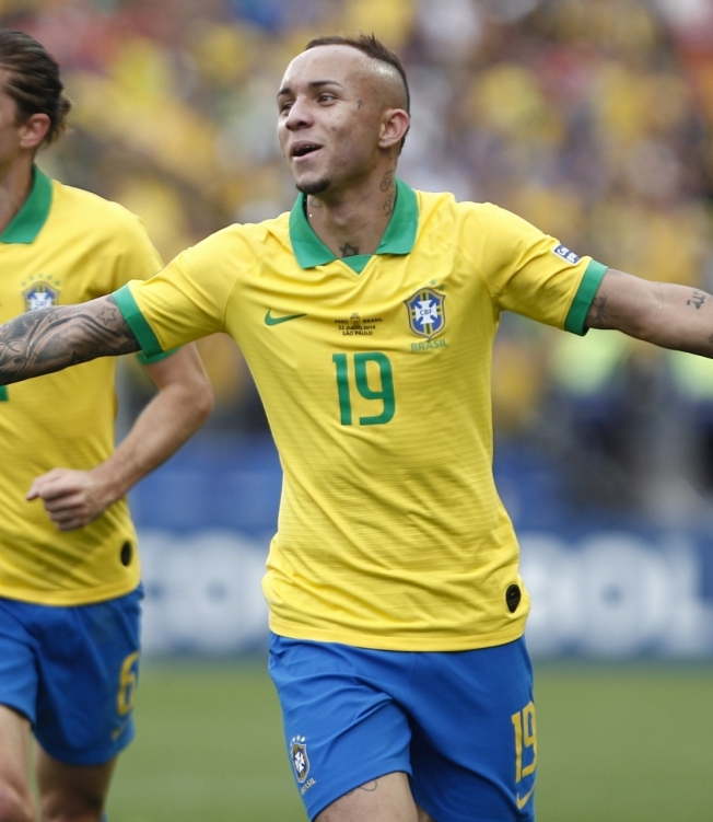 Brazil's Everton (R) is followed by teammate Filipe Luis after scoring the team's third goal against Peru during their Copa America football tournament group match at the Corinthians Arena in Sao Paulo, Brazil, on June 22, 2019. (Photo by Miguel SCHINCARIOL / AFP)