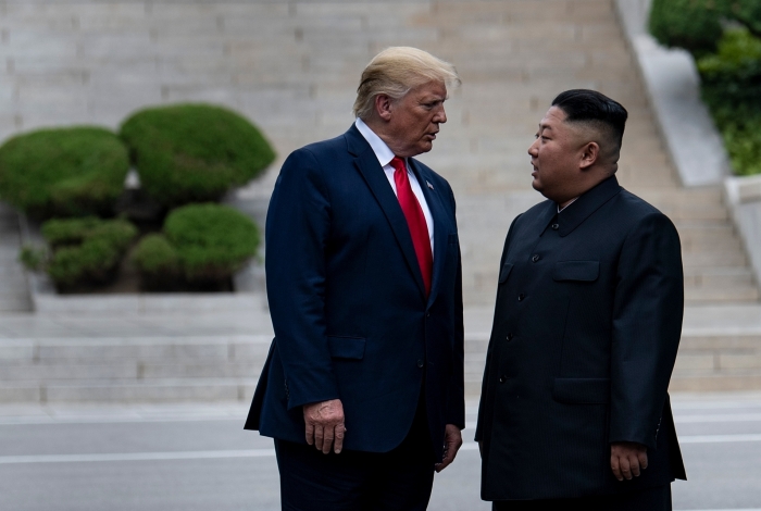 US President Donald Trump and North Korea's leader Kim Jong-un stand on North Korean soil while walking to South Korea in the Demilitarized Zone(DMZ) on June 30, 2019, in Panmunjom, Korea. (Photo by Brendan Smialowski / AFP)