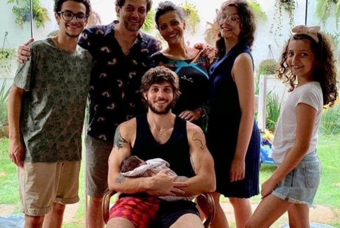 Chay Suede posa para foto em família com a filha no colo