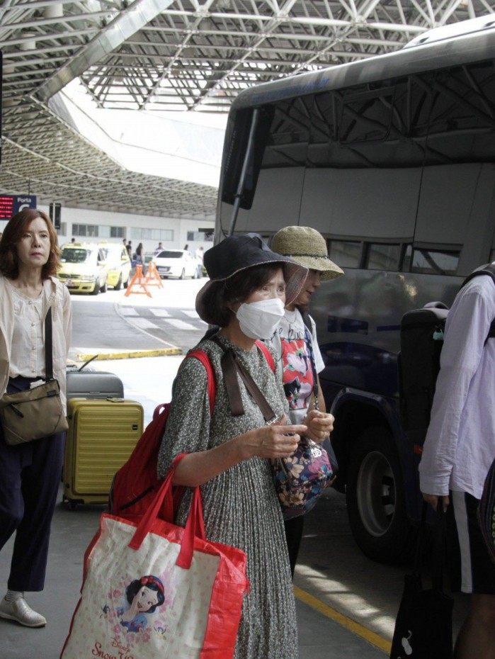 Dezenas de turistas orientais desembarcam no Aeroporto do Gale&atilde;o, na Ilha do Governador, com o uso de m&aacute;scaras protetoras. Foto de 05/02/2020