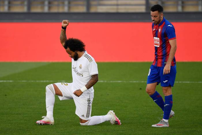 Real Madrid's Brazilian defender Marcelo kneels on the field to celebrate his goal during the Spanish League football match between Real Madrid CF and SD Eibar at the Alfredo di Stefano stadium in Valdebebas, on the outskirts of Madrid, on June 14, 2020. (Photo by PIERRE-PHILIPPE MARCOU / AFP)