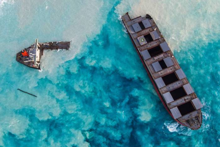 An aerial view taken in Mauritius on August 17, 2020, shows the MV Wakashio bulk carrier, belonging to a Japanese company but Panamanian-flagged, that had run aground and broke into two parts near Blue Bay Marine Park. (Photo by - / AFP)