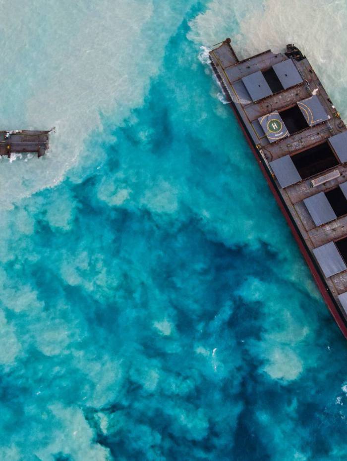 An aerial view taken in Mauritius on August 17, 2020, shows the MV Wakashio bulk carrier, belonging to a Japanese company but Panamanian-flagged, that had run aground and broke into two parts near Blue Bay Marine Park. (Photo by - / AFP)