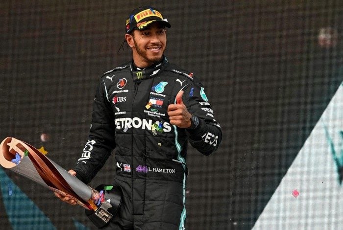 Winner Mercedes' British driver Lewis Hamilton (C) celebrates with the trophy on the podium after the Turkish Formula One Grand Prix at the Intercity Istanbul Park circuit in Istanbul on November 15, 2020. (Photo by OZAN KOSE / POOL / AFP)