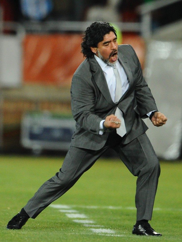 (FILES) In this file photo taken on June 22, 2010 Argentina's coach Diego Maradona celebrates after Argentina's defender Martin Demichelis (not pictured) scored during the Group B first round 2010 World Cup football match Greece vs Argentina at Peter Mokaba stadium in Polokwane. - Argentine football legend Diego Maradona has died at the age of 60, his spokesman announced on November 25, 2020.
Renowned with Brazil's Pele as one of the greatest footballers of all time, the Argentine World Cup winning captain died of a heart attack, having undergone brain surgery earlier this month, a member of his entourage told AFP. (Photo by François-Xavier MARIT / AFP)