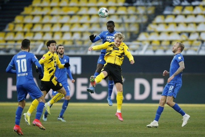 Dortmund's German forward Julian Brandt (2R) and Hoffenheim's Malian midfielder Diadie Samassekou vie for the ball during the German first division Bundesliga football match between Borussia Dortmund and TSG 1899 Hoffenheim in Dortmund, western Germany, on February 13, 2021. (Photo by LEON KUEGELER / POOL / AFP) / DFL REGULATIONS PROHIBIT ANY USE OF PHOTOGRAPHS AS IMAGE SEQUENCES AND/OR QUASI-VIDEO