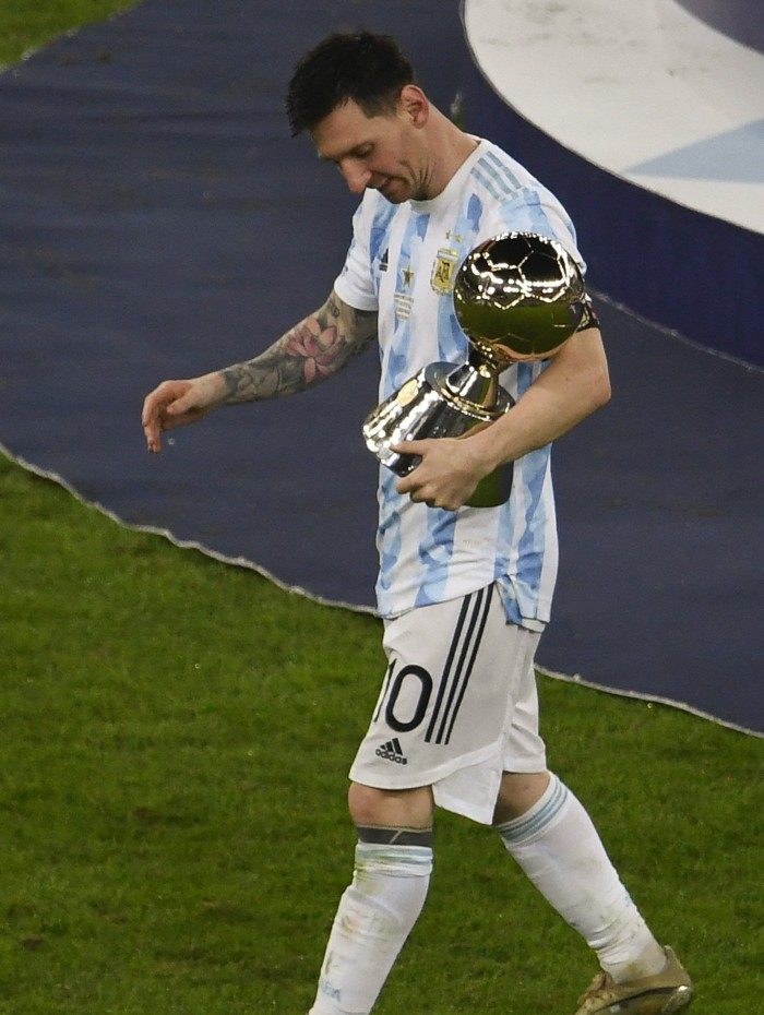 Argentina's Lionel Messi celebrates with the trophy for the championship's Top Scorer, after winning the Conmebol 2021 Copa America football tournament final match against Brazil at Maracana Stadium in Rio de Janeiro, Brazil, on July 10, 2021. (Photo by MAURO PIMENTEL / AFP)