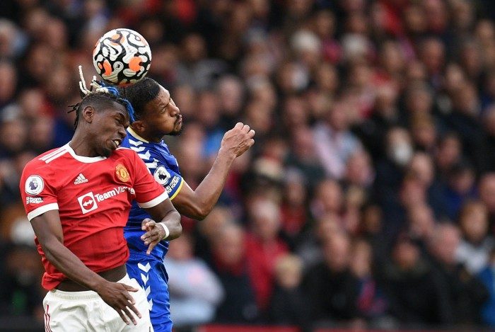 Manchester United's French midfielder Paul Pogba (L) and Everton's Venezuelan striker Salomon Rondon jump for the ball during the English Premier League football match between Manchester United and Everton at Old Trafford in Manchester, north west England, on October 2, 2021.